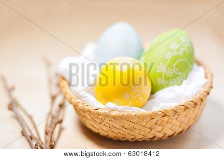 Easter eggs in nest on rustic wooden planks