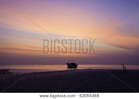 Orange Predawn Skies And A Stranded Lone Boat
