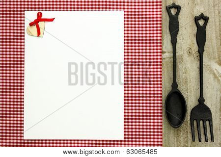 Blank white menu with cast iron spoon and fork