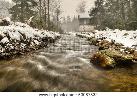 mountain river with a mill