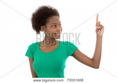 Young isolated african american in a green shirt pointing at something.