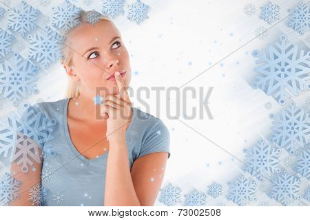 Close up of a charming pensive woman against snowflake frame