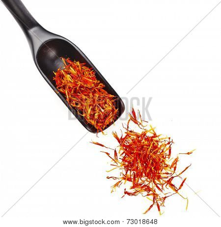 Heap pile of Saffron Stamens in black wooden scoop , isolated on white background