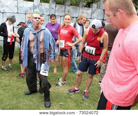 MUSKOGEE, OK - Sept. 13: A bloody zombie looks for runners during the Castle Zombie Run at the Castle of Muskogee in Muskogee, OK on September 13, 2014. 