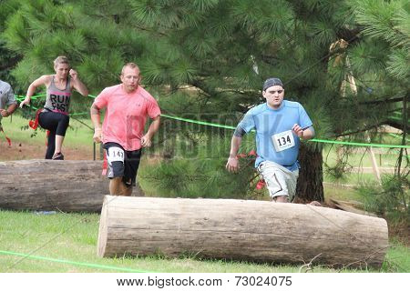 MUSKOGEE, OK - Sept. 13: Athletes jump over obstacles during the Castle Zombie Run at the Castle of Muskogee in Muskogee, OK on September 13, 2014. 