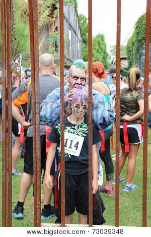 MUSKOGEE, OK - Sept. 13: A bloody zombie bites a boy during the Castle Zombie Run at the Castle of Muskogee in Muskogee, OK on September 13, 2014. 