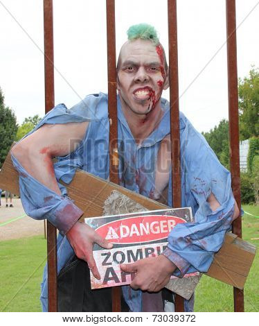MUSKOGEE, OK - Sept. 13: A bloody zombie looks waits for runners during the Castle Zombie Run at the Castle of Muskogee in Muskogee, OK on September 13, 2014. 