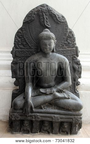 KOLKATA, INDIA - NOV 24: Buddha in Bhumisparsha mudra, from 10th century found in Bihar now exposed in the Indian Museum in Kolkata, on Nov 24, 2012