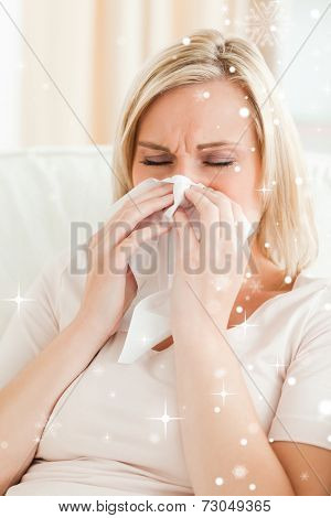 Portrait of an ill woman blowing her nose with snow falling