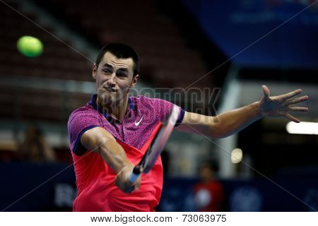 SEPTEMBER 23, 2014 - KUALA LUMPUR, MALAYSIA: Bernard Tomic of Australia makes a backhand return in his first round match at the Malaysian Open Tennis 2014 event. This is an ATP sanctioned tournament.
