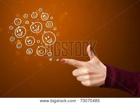 Group of happy hand drawed smiley faces coming out of gun shaped hands