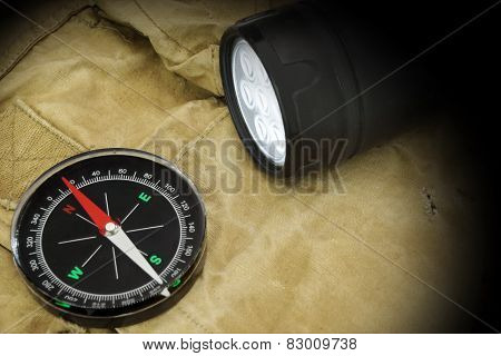 Searchlight And Compass On Backpack