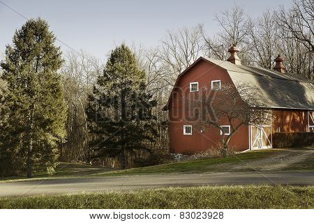 Old Red Barn In Field With Trees