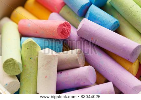 Colorful crayons for drawing on the pavement close-up