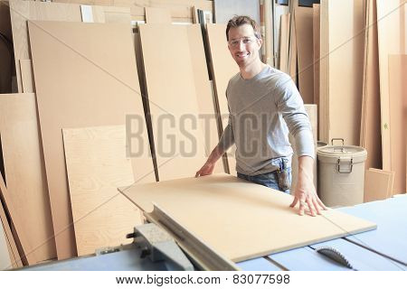 A carpenter working hard at the worksop