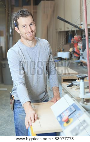 A carpenter working hard at the worksop
