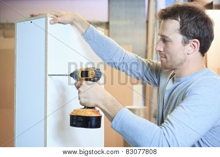 A carpenter working hard at the worksop