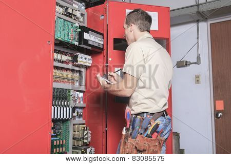 machinist worker technicians at work adjusting lift with spanner