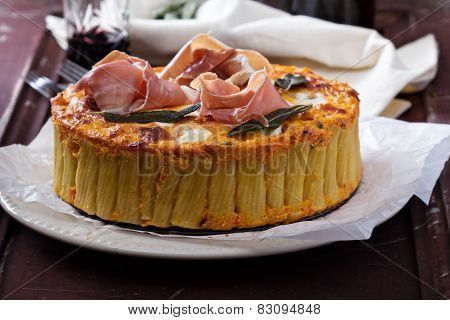Pasta pie with cheese sauce and sage