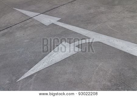 white arrow sign on road