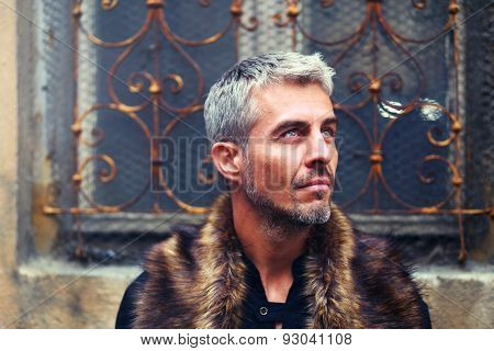 Portrait Of A Sexy Man In Wolf  Fur And Ornamental Medieval Window On Background