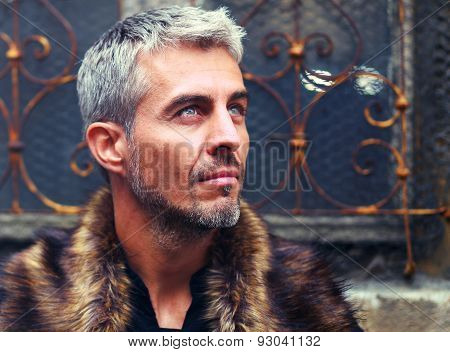Portrait Of A Sexy Man In Wolf  Fur And Ornamental Medieval Window On Background