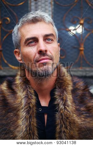 Portrait Of A Sexy Man In Wolf  Fur And Ornamental Medieval Window On Background
