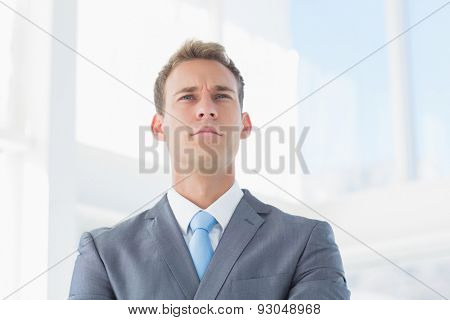 Serious businessman looking away in the offie