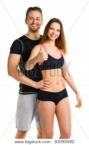 Athletic Man And Woman After Fitness Exercise With Thumbs Up On The White