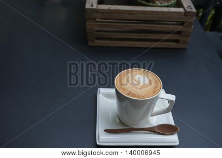 hot fresh coffee in white cup and wooden basket on black table and white saucer cappuccino coffee mocha coffee espresso coffee latte coffee