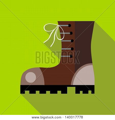 Hiking boot icon in flat style on a green background