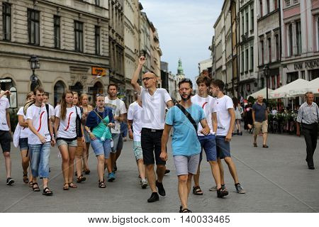 CRACOW POLAND - JULY 24 2016: Pilgrims of World Youth Day sing and dance on the Main Square in Cracow. Poland