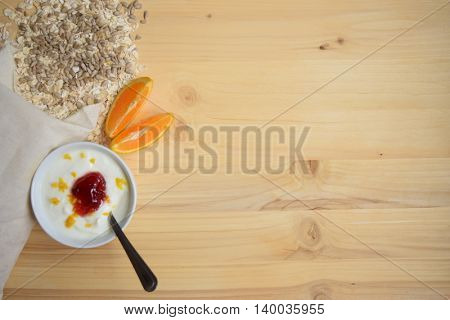 Healthy Breakfast. Yogurt with muesli  on wooden background. Health and diet concept. Top view.