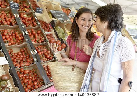 Senior woman going to grocery store with help of carer