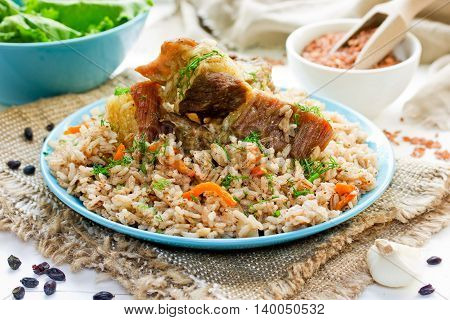 Rice pilaf with lamb meat and vegetables selective focus