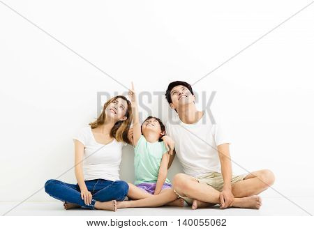 Happy Young Family pointing and looking up