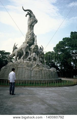 GUANGZHOU / CHINA - CIRCA 1987: A man looks at the Five Rams Sculpture on Yuexiu Hill in Guangzhou.