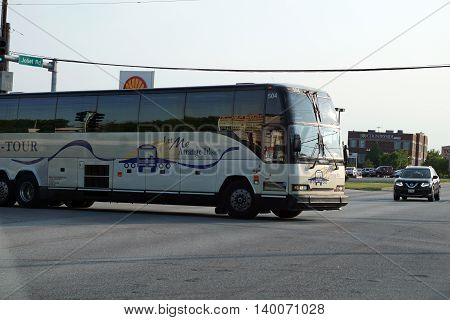 COUNTRYSIDE, ILLINOIS / UNITED STATES - MAY 21, 2016: A tour bus enters an intersection in Countryside, Illinois.