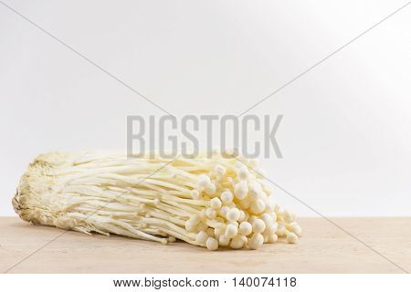 Enoki mushroom  on wood white background.food for health and raw food.