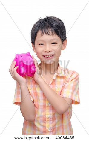 Little asian boy smiling with piggy bank over white