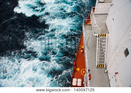 Cargo ship at sea during a storm. part of the deck and the sea depths