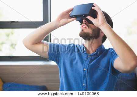 Close-up of man using virtual reality glasses at home