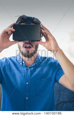 Close-up of man using virtual reality glasses at home