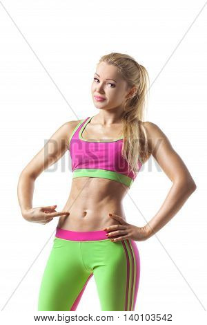 Fitness woman showing her stomack isolated on white background. Healthy lifestyle concept of happy young girl