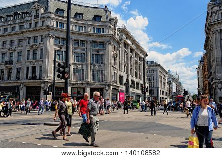 LONDON - JULY 1 2014: Oxford Circus with unidentified people in London. Up to over 40.000 pedestrians per hour pass the junction it is the highest pedestrian volumes recorded in London.