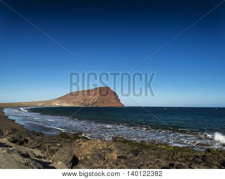 la tejita kite surfing beach and montana roja landmark in south tenerife spain