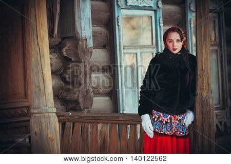Russian girl in the village in winter