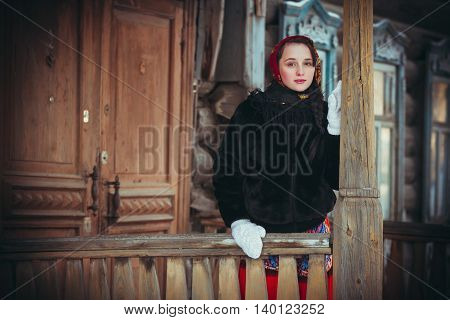 Russian girl in the village in winter