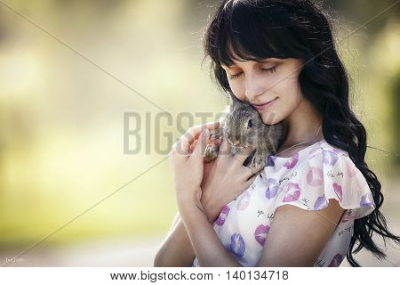 the girl with a small rabbit in his hands