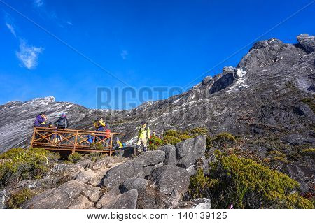 Mount Kinabalu,Ranau,Malaysia-March 13.2016:Group of climber enjoying beautiful view of the Ranau and Kundasang town from viewpoint Mountain Kinabalu.